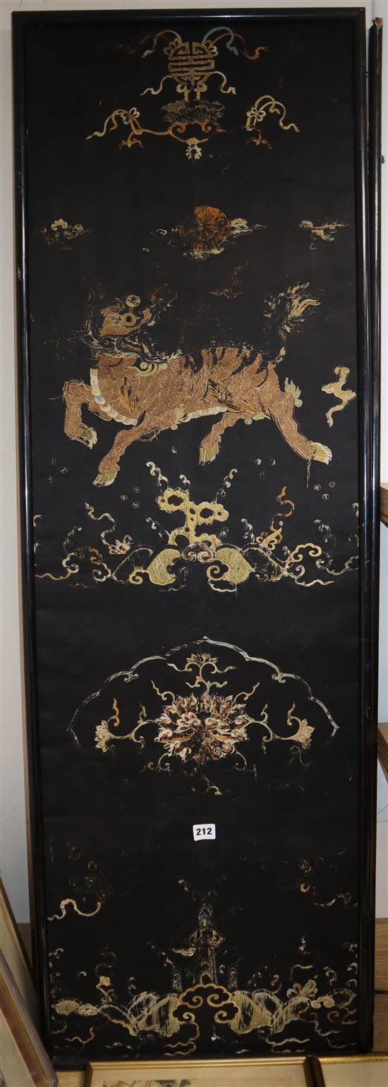 A pair of Chinese/Tibetan embroidered black satin qilin panels, late 19th/early 20th century, 144 x 44cm, worn